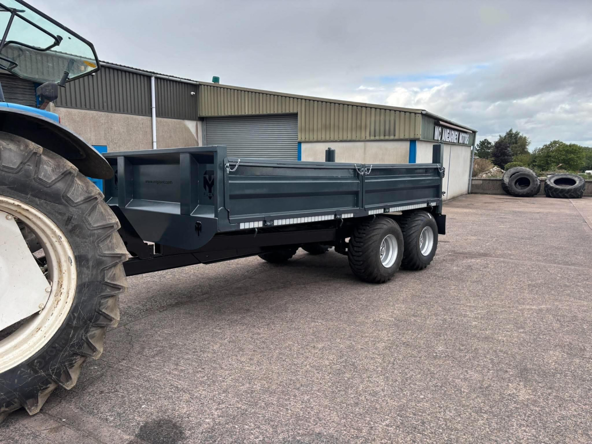 Graphite grey MT Plant dropside trailer hitched to a tractor