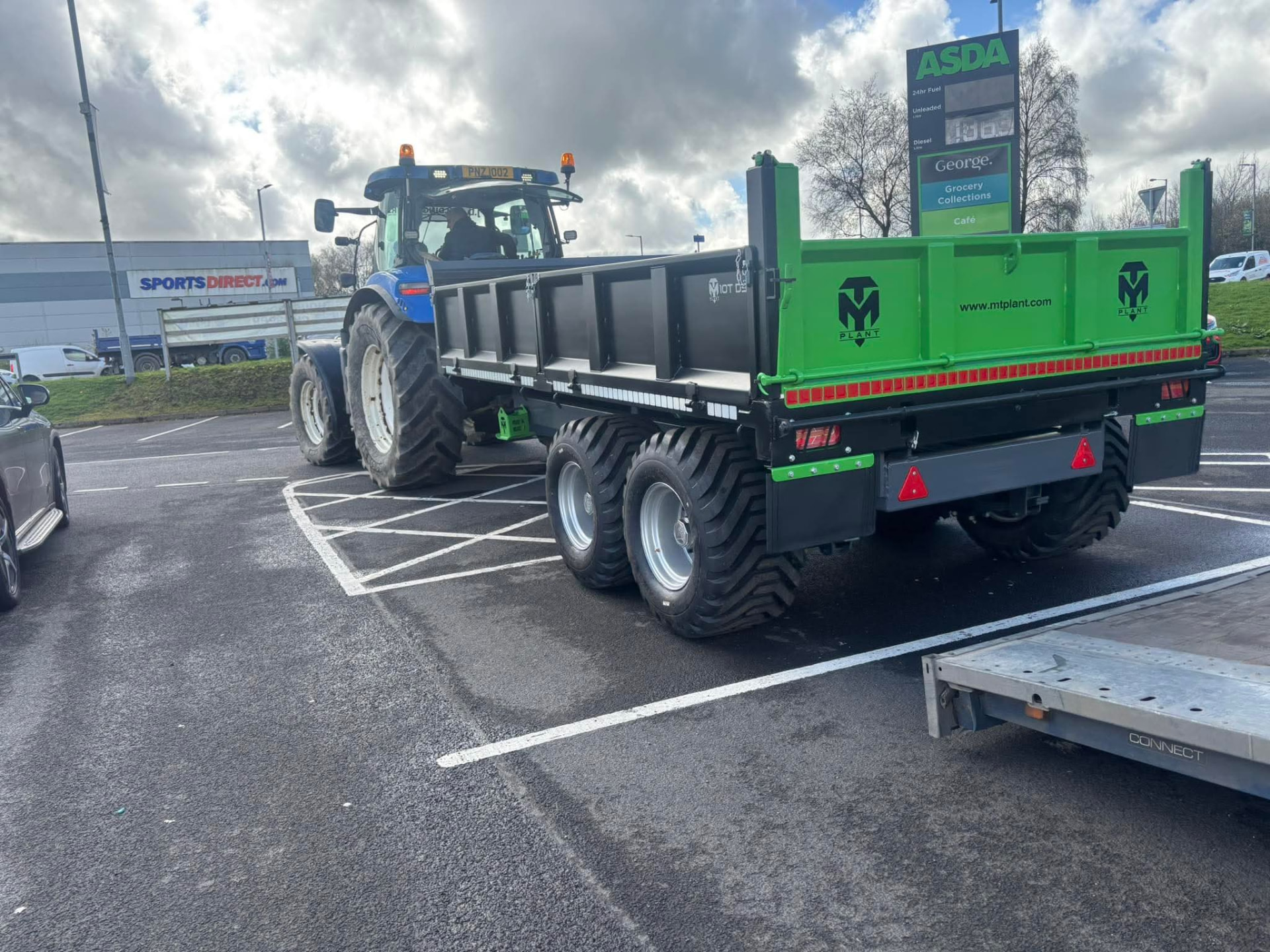 Green MT Plant 10T dropside trailer hitched to a tractor